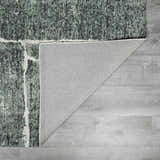 Close-up of the Janek II Modern Abstract Area Rug showing its green, black, and white abstract design and hand-tufted texture. Fold