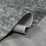 Close up of the hand tufted Janek II modern abstract area rug showing texture and backing. Fold