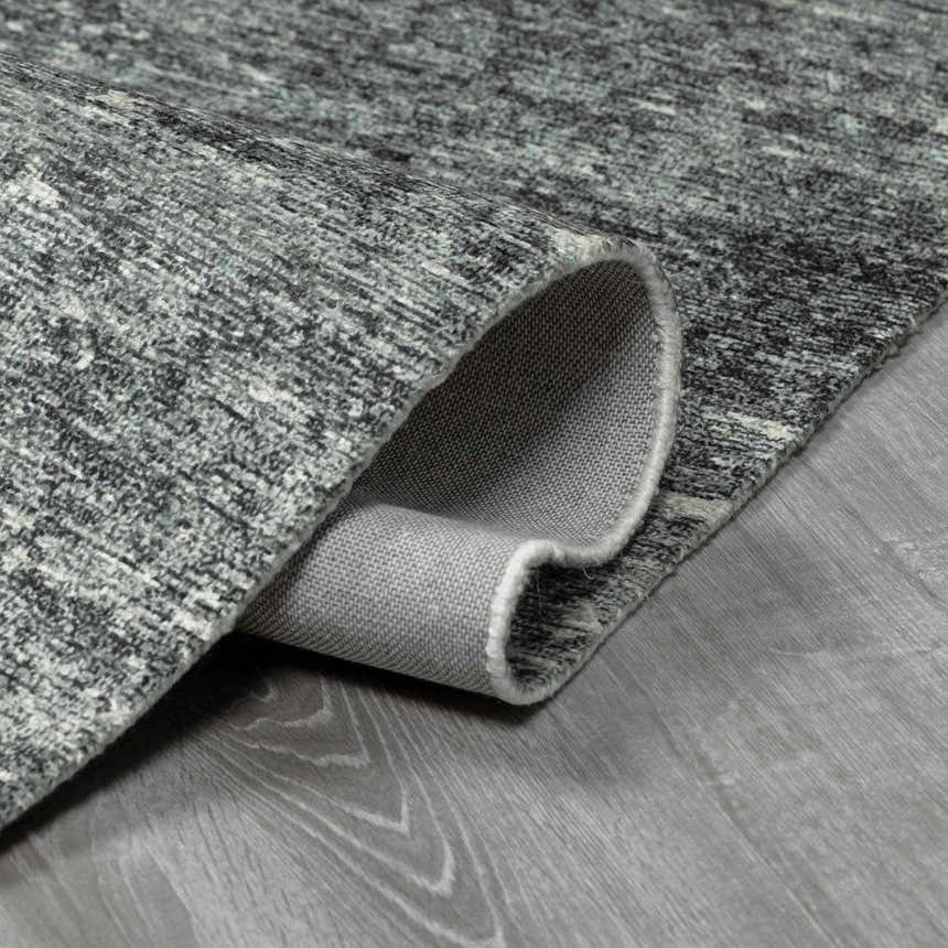 Close up of the hand tufted Janek II modern abstract area rug showing texture and backing. Fold