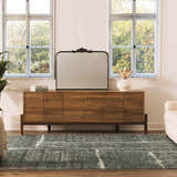 Living room scene with a gray Janek II Modern Abstract Area Rug, wood console table, and large mirror. Roomscene-Rectangle