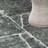 Close up of the Janek II Modern Abstract Area Rug with gray tones and a white geometric pattern. Styleshot