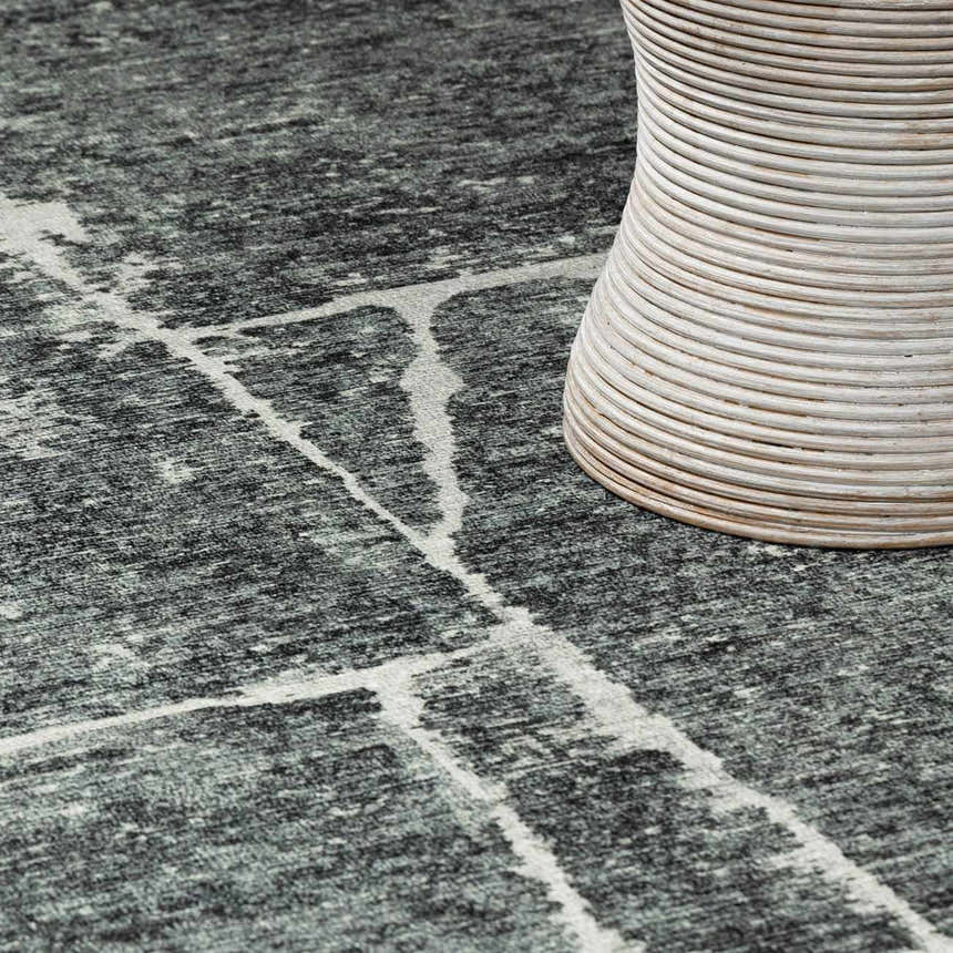Close up of the Janek II Modern Abstract Area Rug with gray tones and a white geometric pattern. Styleshot