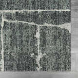 Close-up of the Janek II Modern Abstract Area Rug. Hand-tufted polyester rug in shades of gray with a white abstract pattern. Swatch