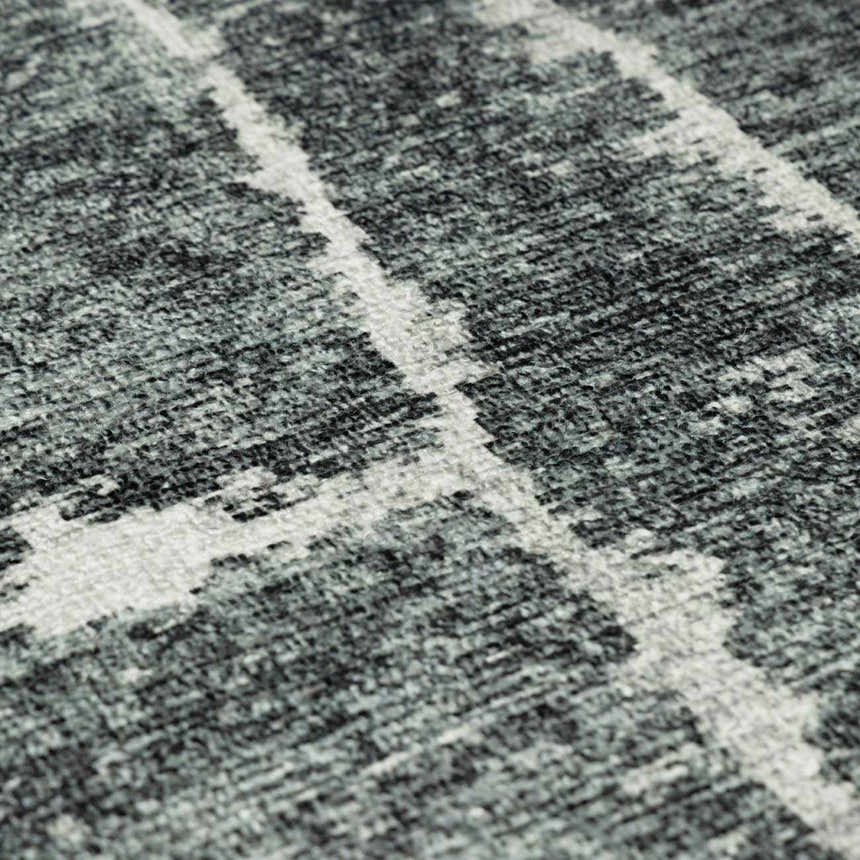 Close-up of the Janek II Modern Abstract Area Rug. Hand-tufted polyester rug with a black, gray, and white geometric pattern. Texture