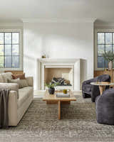 Living room with fireplace and beige sofa styled with the Collins Avenue III Vintage Damask Area Rug. Roomscene-Rectangle