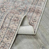 Close-up of the Collins Avenue III Vintage Damask Area Rug showing beige, dark red, and ivory damask pattern. Fold