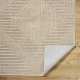Close-up of the Briana Brown Washable Area Rug, showcasing its beige geometric pattern and machine-woven texture on wood floor. Fold
