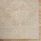 Close up of Briana Brown Washable Area Rug. Beige rug with a contemporary geometric pattern and a textured look. Corner
