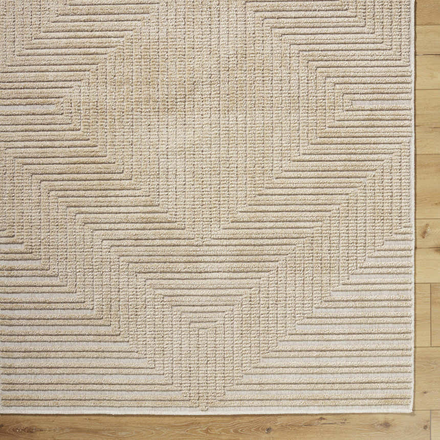 Close up of Briana Brown Washable Area Rug. Beige rug with a contemporary geometric pattern and a textured look. Corner