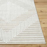 Close-up of Briana Beige Washable Area Rug. Contemporary design with geometric pattern and textured pile. Beige and off-white colors. Front