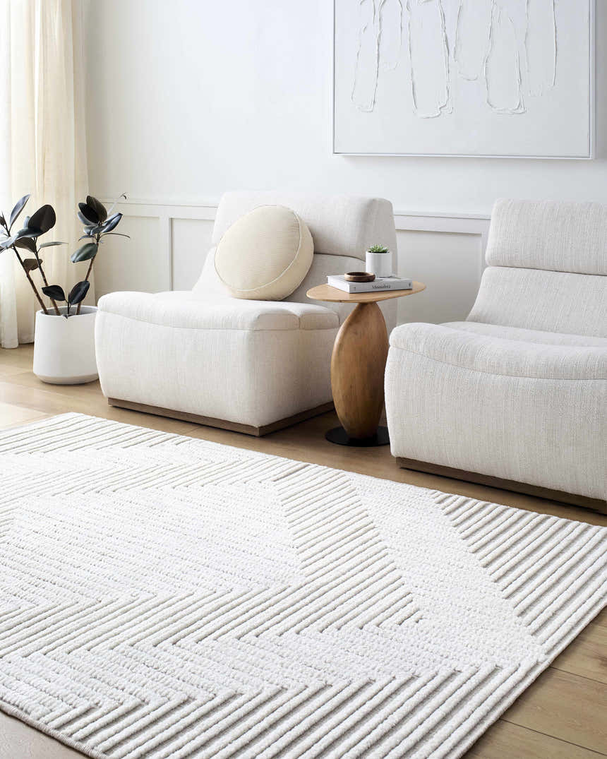 Living room scene with white chairs and Briana Beige Washable Area Rug featuring a geometric design. Roomscene-Rectangle