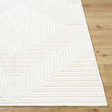 Close-up of the Briana Off-White Washable Area Rug. Cream rug with a geometric, maze-like design and soft texture. Front