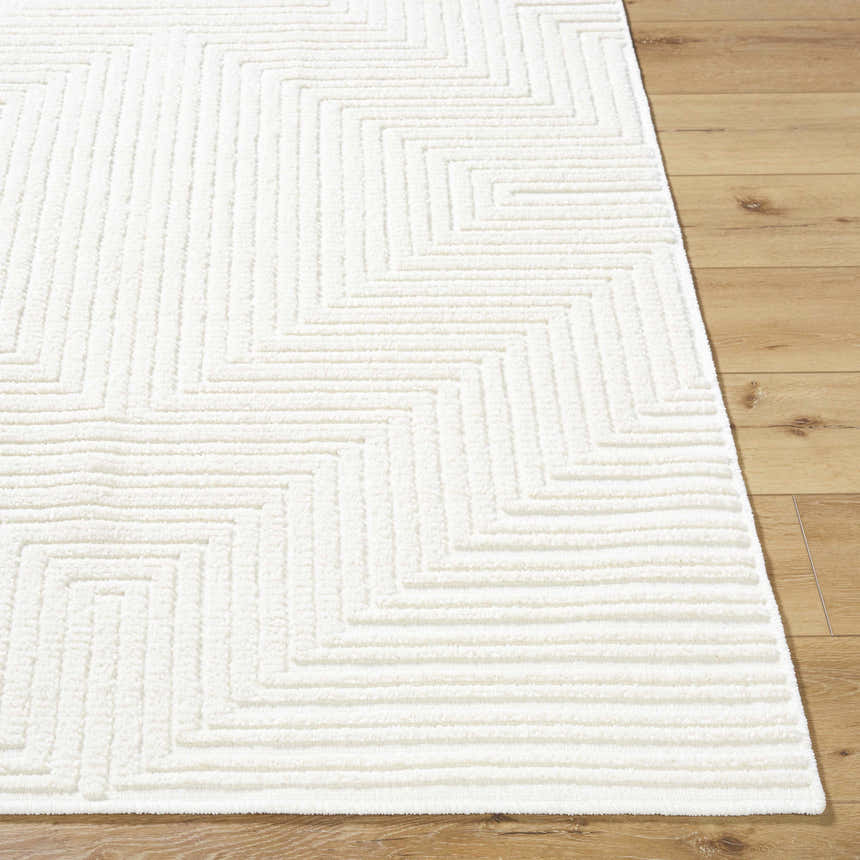 Close-up of the Briana Off-White Washable Area Rug. Cream rug with a geometric, maze-like design and soft texture. Front