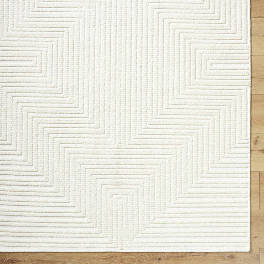 Close-up of the Briana Off-White Washable Area Rug, showing a geometric maze pattern and soft, textured pile. Corner