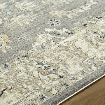 Close-up of the Noci Ivory Persian rug. Machine woven polyester with beige, gray, and teal floral pattern. Texture
