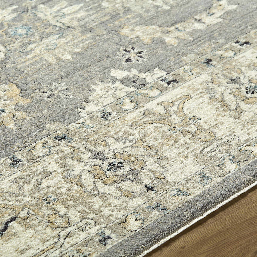 Close-up of the Noci Ivory Persian rug. Machine woven polyester with beige, gray, and teal floral pattern. Texture