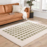 Living room with tan leather sofa and Baback Green Washable Area Rug with a geometric diamond pattern. Roomscene-Rectangle