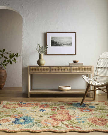 Farmhouse entryway with floral Braith Area Rug, wood console table, and white wicker chair. Roomscene-Rectangle