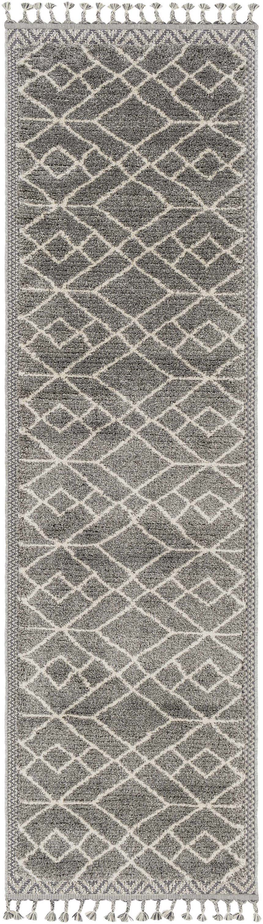 Close-up of the Ballybunnion Area Rug. Charcoal gray rug with a light beige diamond pattern and tassels. Design-Runner-21010