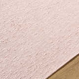Close-up of the hand woven Breena Blush Washable Area Rug showing texture and color. Texture