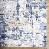 Close-up of the Bazyli Area Rug. Contemporary style with ivory, light gray, navy, peach, and white abstract pattern. Corner