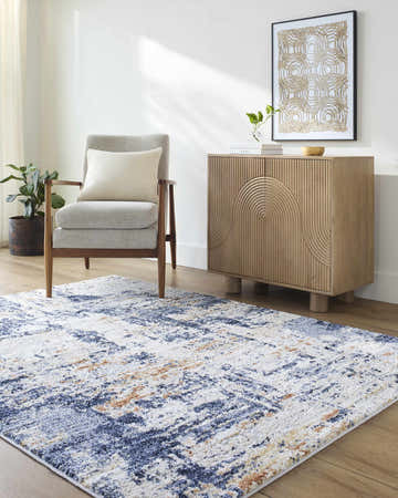 Living room scene with a Bazyli Area Rug in ivory, light gray, navy, and peach. Roomscene-Rectangle