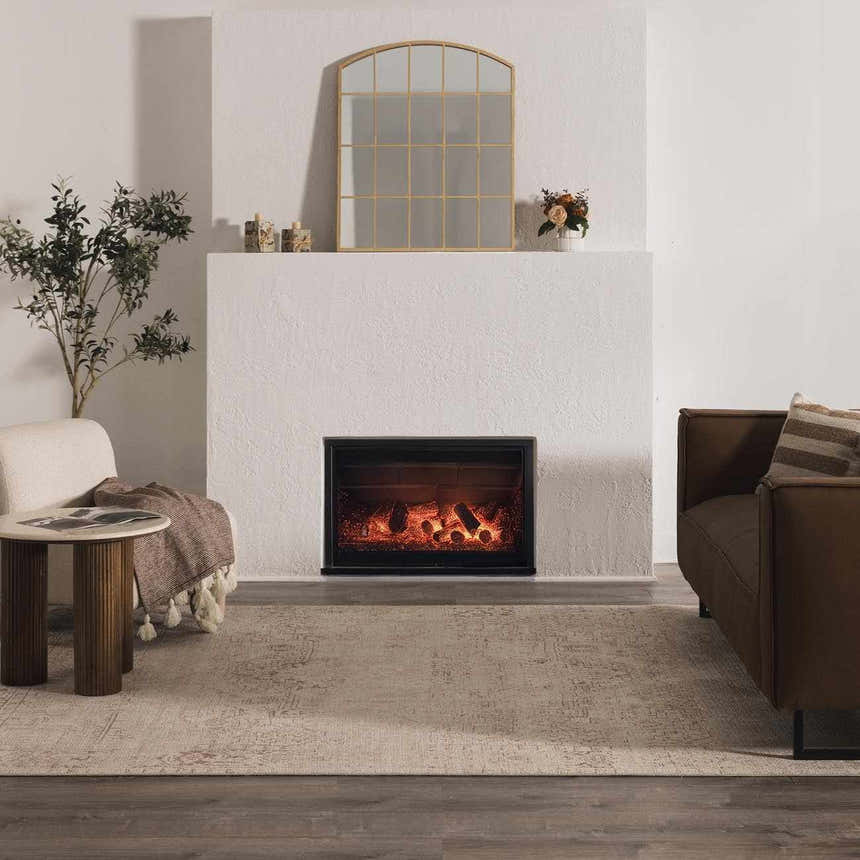 Living room scene with a Galey Alix Collins Avenue Vintage Medallion Rug in beige, brown sofa, and fireplace. Roomscene-Rectangle
