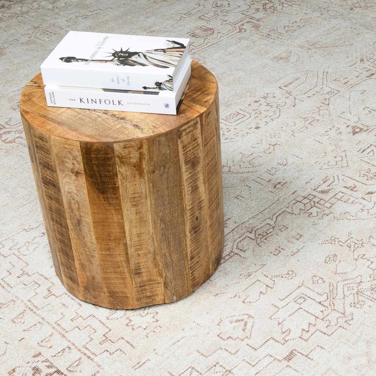Close-up of Galey Alix Collins Avenue V Vintage Medallion Rug with beige and dark red pattern, styled with wood side table. Styleshot