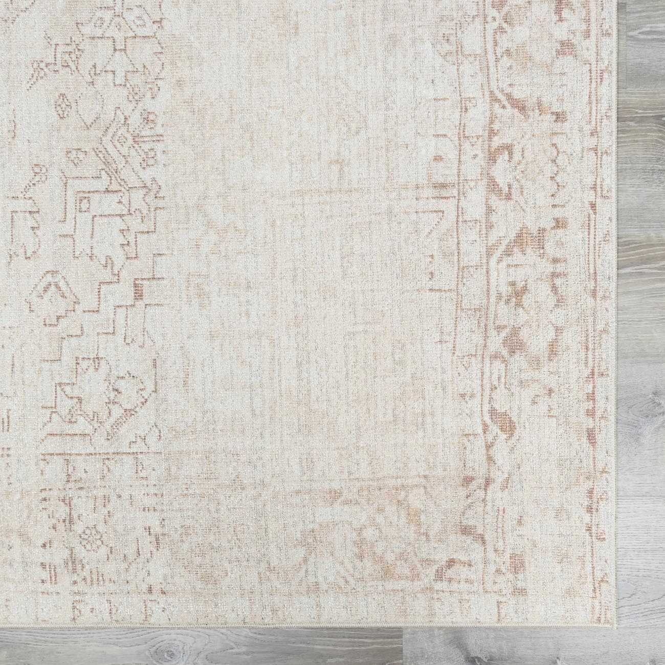 Close-up of Galey Alix Collins Avenue V Vintage Medallion Rug. Beige rug with faded dark red, pink, and ivory traditional medallion pattern. Swatch