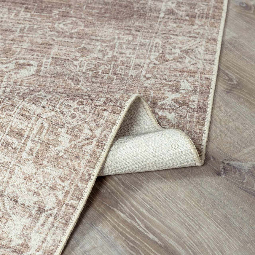 Close-up of the Galey Alix Collins Avenue VI Vintage Medallion Rug. Dark brown and ivory traditional rug with a distressed medallion pattern. Fold