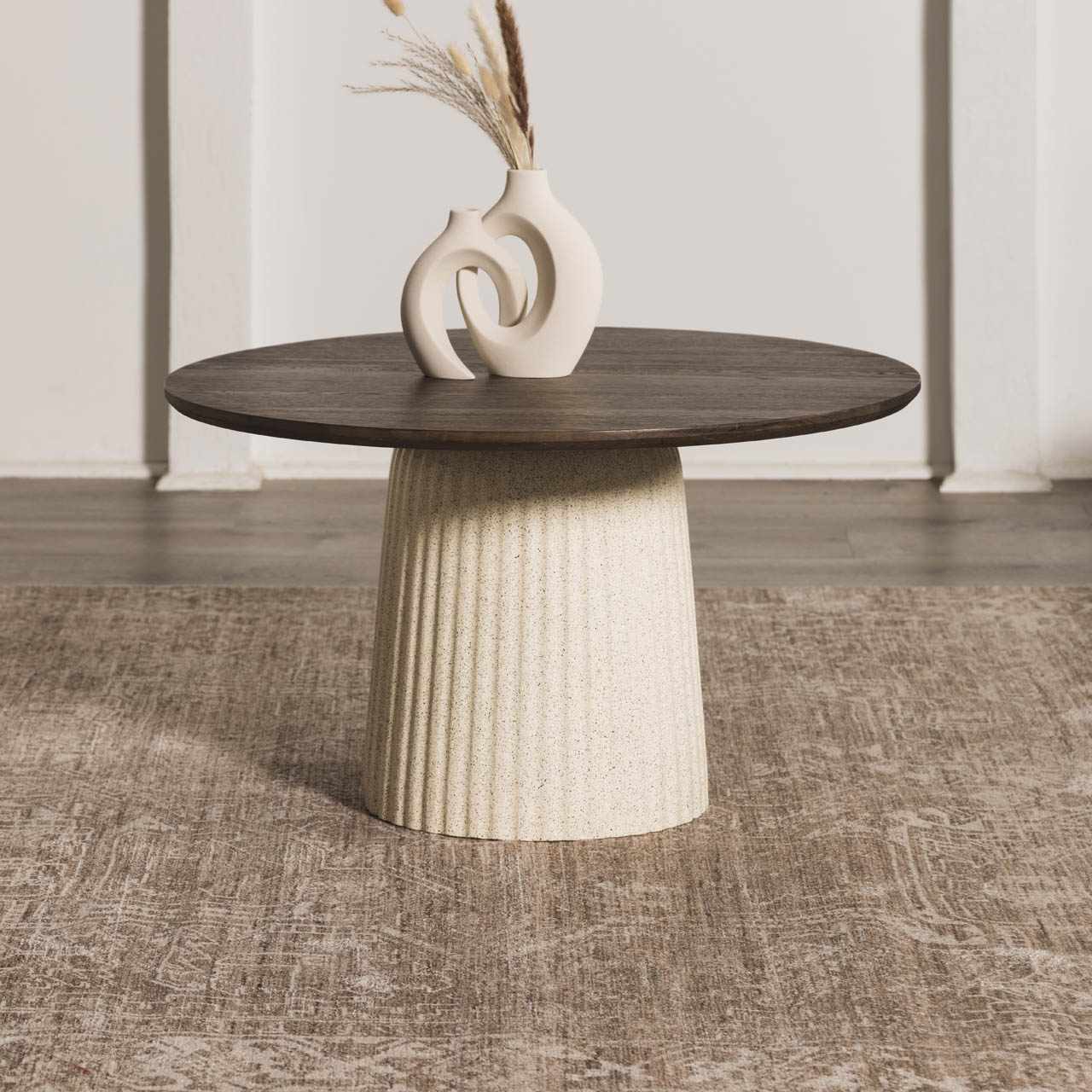 Close up of the Galey Alix Collins Avenue VI Vintage Medallion Rug with a dark wood table and a white vase. Styleshot
