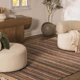 Living room scene with a colorful striped Brenda Crimson Area Rug, cream poufs, wood console table, and potted olive tree. Roomscene-Rectangle