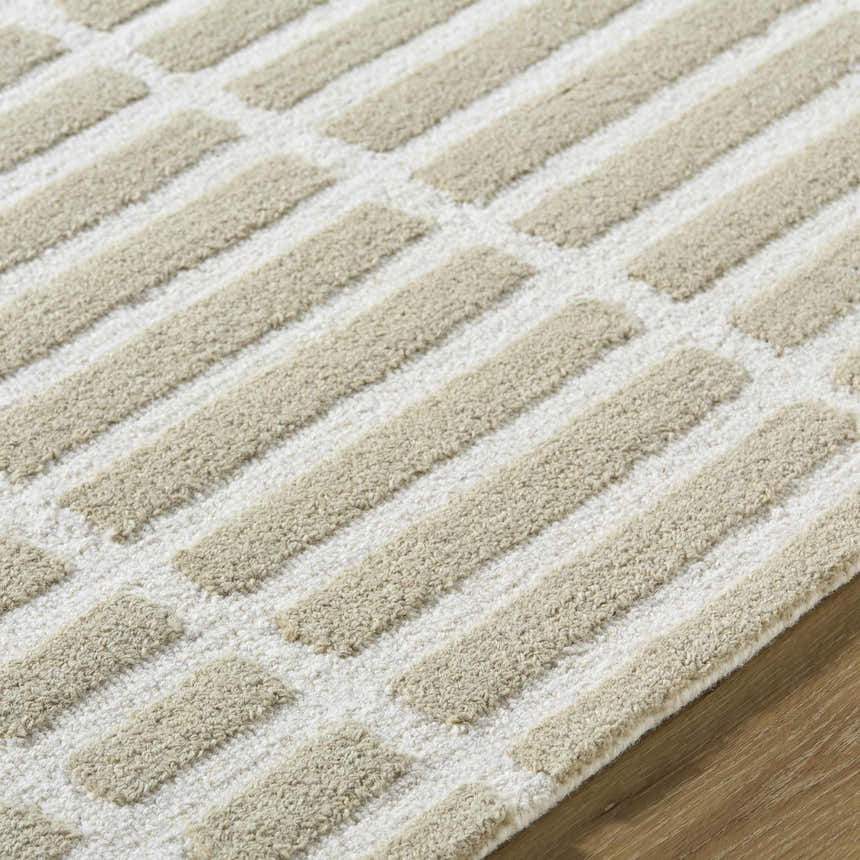 Close-up of the Bendek Beige Area Rug. Features a contemporary beige and ivory striped design with a hand-tufted, textured wool pile. Texture