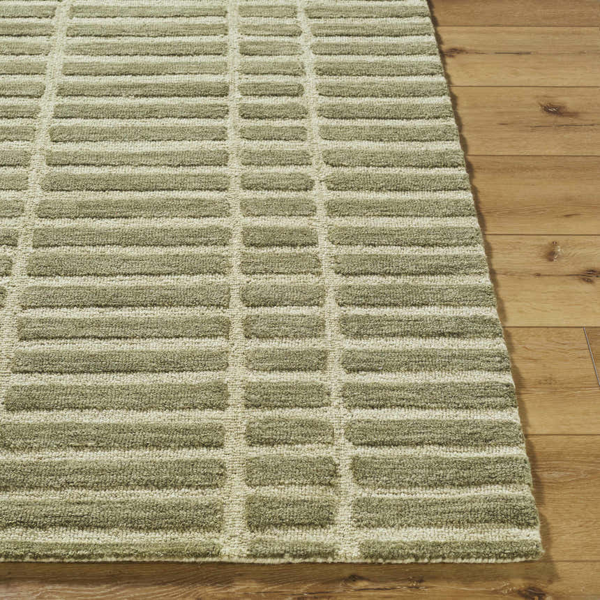 Close up of the hand-tufted Bendek Olive Area Rug. Beige and olive wool rug with a contemporary rectangular pattern. Front