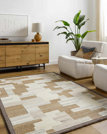 Living room scene with a Berker Area Rug in beige, cream, and taupe, complementing the modern furniture and light wood tones. Roomscene-Rectangle
