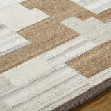 Close-up of the hand-tufted Berker Area Rug. Beige, cream, charcoal, and taupe wool form a contemporary geometric pattern. Texture