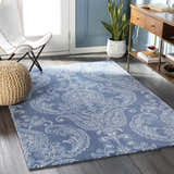 Living room scene with blue walls and Simpatico Candice Olson rug. The rug has a paisley pattern in cream and blue. Roomscene-Rectangle