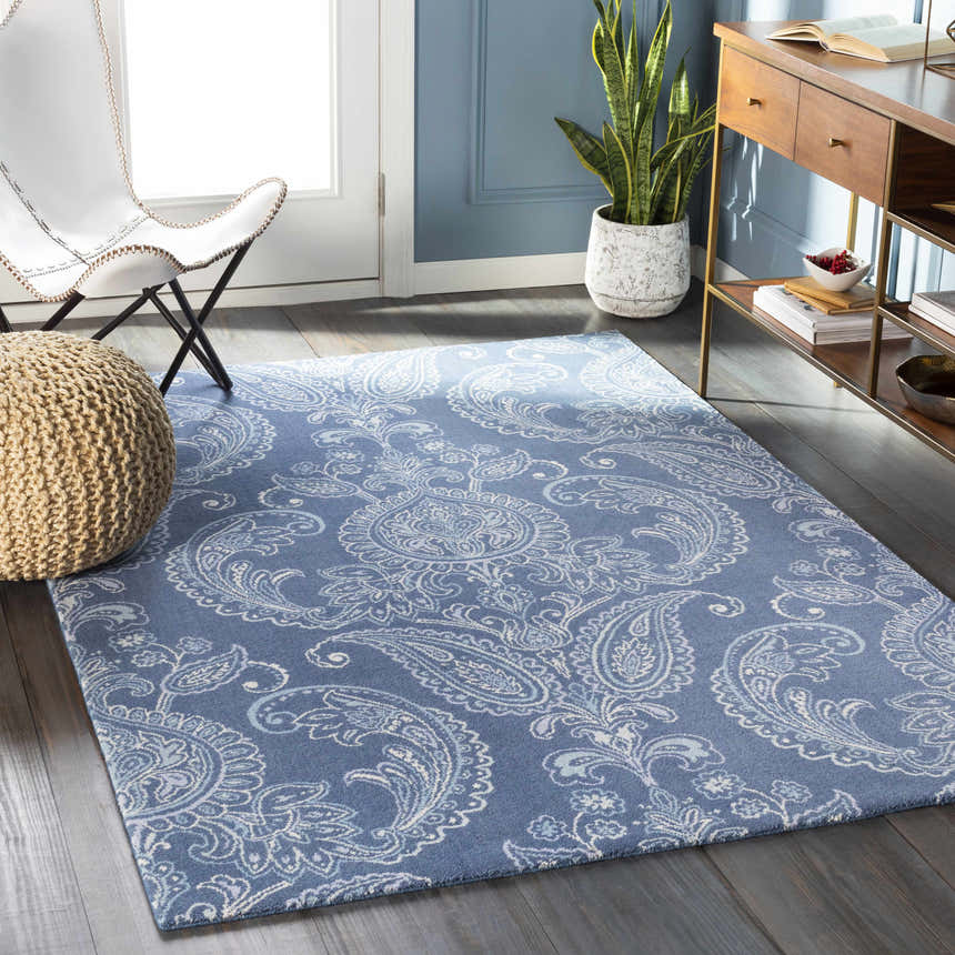 Living room scene with blue walls and Simpatico Candice Olson rug. The rug has a paisley pattern in cream and blue. Roomscene-Rectangle