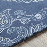 Close-up of Simpatico Candice Olson x LIVABLISS SPO-1000 Area Rug. Navy rug with cream, light blue, and pale blue floral paisley pattern. Texture
