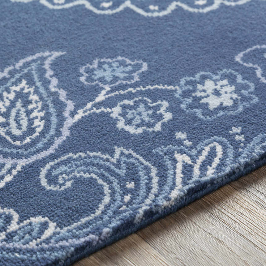 Close-up of Simpatico Candice Olson x LIVABLISS SPO-1000 Area Rug. Navy rug with cream, light blue, and pale blue floral paisley pattern. Texture