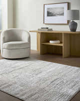 Contemporary living room with a cream swivel chair and the Aramis Area Rug in cream and light gray. Roomscene-Rectangle