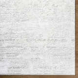Close up of the cream and ivory Aramis Area Rug showing its textured, contemporary design. Corner