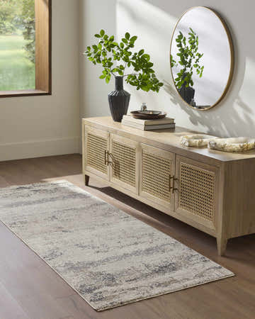 Entryway scene with a Behzad Ivory runner rug, wood floors, and a light wood console table with a round mirror. Roomscene-Runner