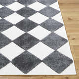 Close-up of Bosley Black Washable Area Rug. Contemporary style with a black and off-white diamond pattern. Machine woven texture. Front
