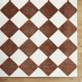 Close-up of the Bosley Brown Washable Area Rug. Features a brown and off-white diamond pattern with a textured weave. Corner