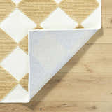 Close-up of the Bosley White Washable Area Rug showing a mustard and white diamond pattern and machine woven construction. Fold