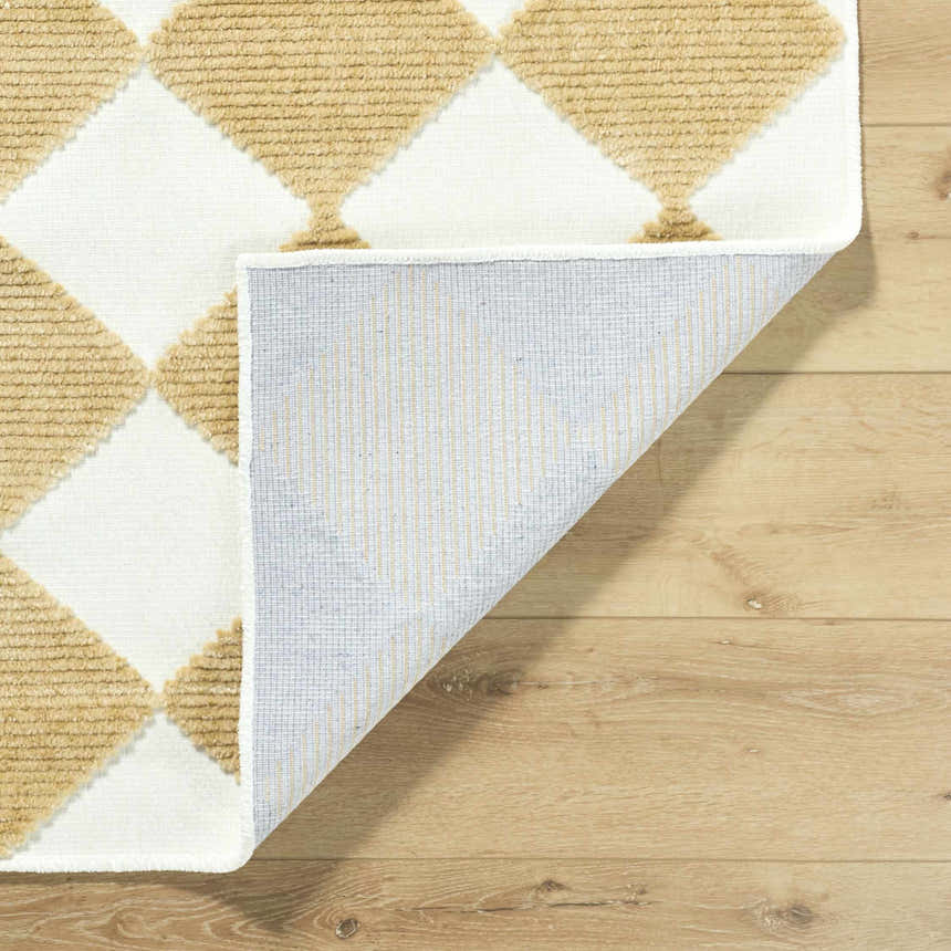 Close-up of the Bosley White Washable Area Rug showing a mustard and white diamond pattern and machine woven construction. Fold