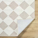 Close-up of Bosley Beige Washable Area Rug showing diamond pattern, beige and cream colors, and machine-woven texture. Fold