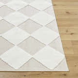 Close-up of the Bosley Beige Washable Area Rug showing its cream diamond pattern and soft texture on a wood floor. Front