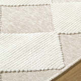Close-up of the Bosley Beige Washable Area Rug featuring a modern beige and cream checkerboard pattern and plush texture. Texture